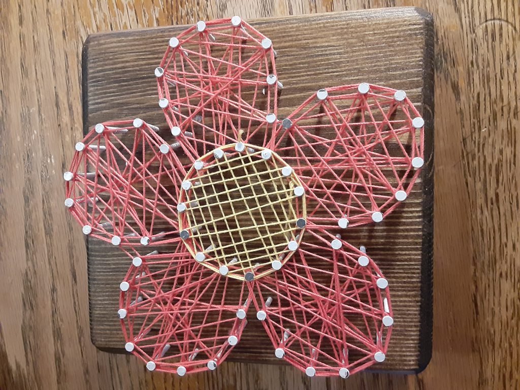 Wooden Flower with yarn wrapped around nails